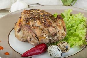 Quail grilled on the plate and wooden background photo