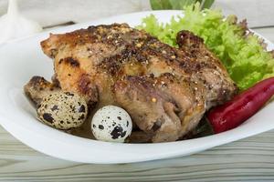 Quail grilled on the plate and wooden background photo