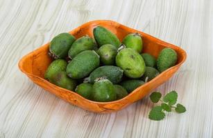 Feijoa in a bowl on wooden background photo