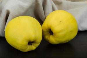 Quince on wooden background photo