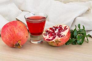 Pomecranet juice on wooden background photo