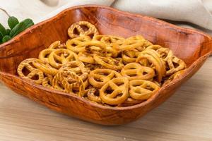 Pretzel in a bowl on wooden background photo