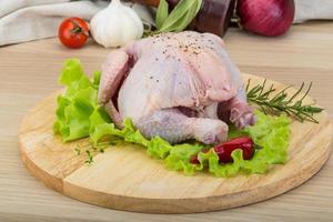 Quail on wooden board and wooden background photo