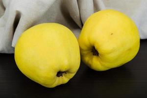 Quince on wooden background photo