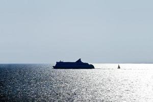 liner and boat in Baltic Sea in evening photo