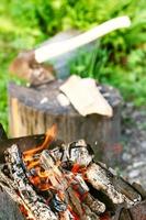 firewood burning in outdoor brazier close up photo