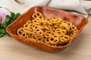 Pretzel in a bowl on wooden background photo