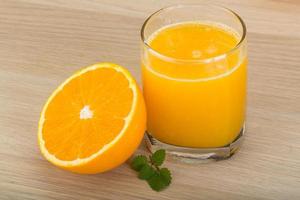 Orange juice on wooden background photo