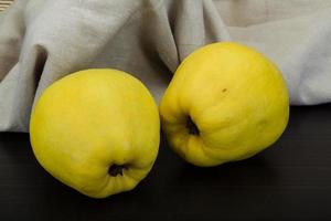 Quince on wooden background photo