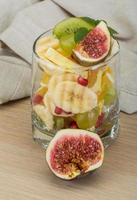 Fruit salad on wooden background photo