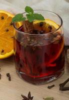Mulled wine on wooden background photo