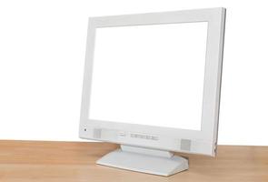 side view of grey computer display on wood table photo