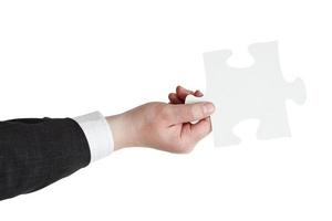 male hand holding big white paper puzzle piece photo