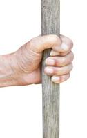 male hand holds old wooden stick photo