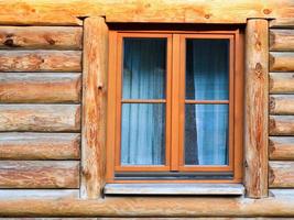 wall with window of modern log house in village photo