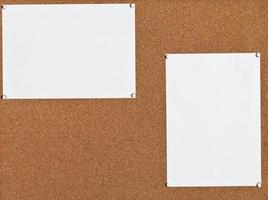 white sheets of paper on cork board photo