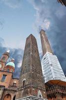Two towers - symbol of city under dramatic sky in Bologna, Italy photo