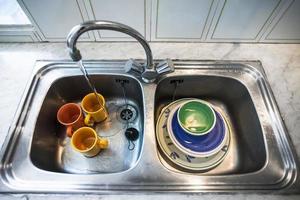 Dirty dishes in kitchen sink photo
