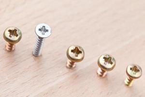 range of screws wrapped in wooden plank photo