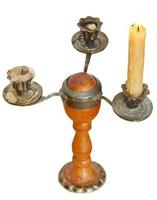 triple candlesholder with one lighted candle photo