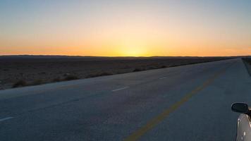 sunset over Desert Highway Road 15 in Jordan photo