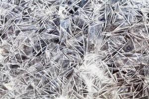 ice crystals over frozen puddle photo