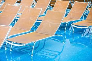 textile chairs on wet deck of cruise liner photo