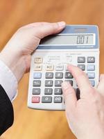 calculator in businessman hands photo