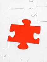 red piece on assembled puzzles photo