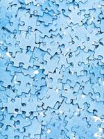 many disassembled blue puzzle pieces photo