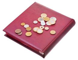 different coins on red numismatics album photo