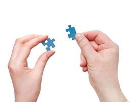 male and female hands with little puzzle pieces photo