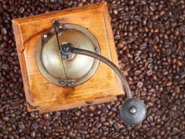 retro manual coffee mill on roasted beans photo