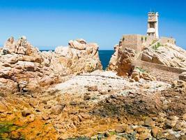 Paon Lighthouse on pink granite coast of Brehat photo