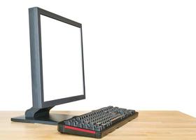 side view computer display and keyboard on table photo