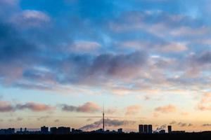 dark blue sky over city in cold winter sunrise photo