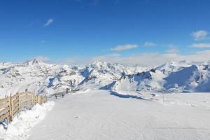 skiing road on mountain snow slope in Paradiski region photo