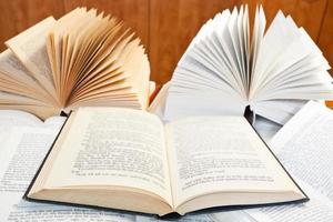 open books on wooden table photo