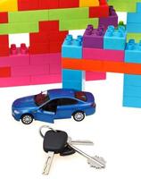 keys, model car, plastic block house photo