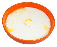 hot semolina porridge with butter in orange bowl photo