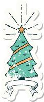 worn old sticker of a tattoo style christmas tree with star vector