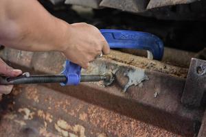 Auto Mechanic with G clamps in hand on Blurred Background. photo