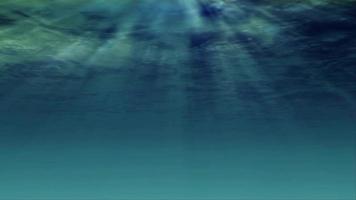 Underwater light filters down through blue water - Loop video