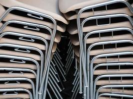 stack of plastic chairs in outdoor cafe photo