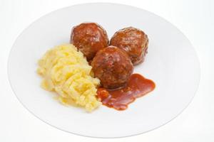 meatballs under meat sauce and mashed potatoes photo