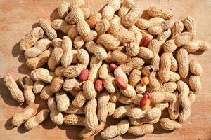 roast peanuts on wooden board photo