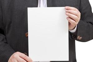 man holds blank sheet of paper in hands photo