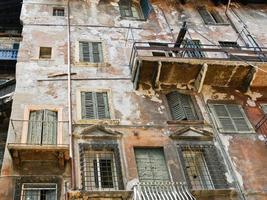 shabby facade of old house in center of Verona photo