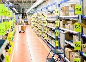 stands with carton boxes in storage warehouse photo