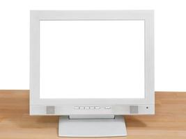 Vista frontal de la pantalla gris de la computadora en la mesa de madera foto